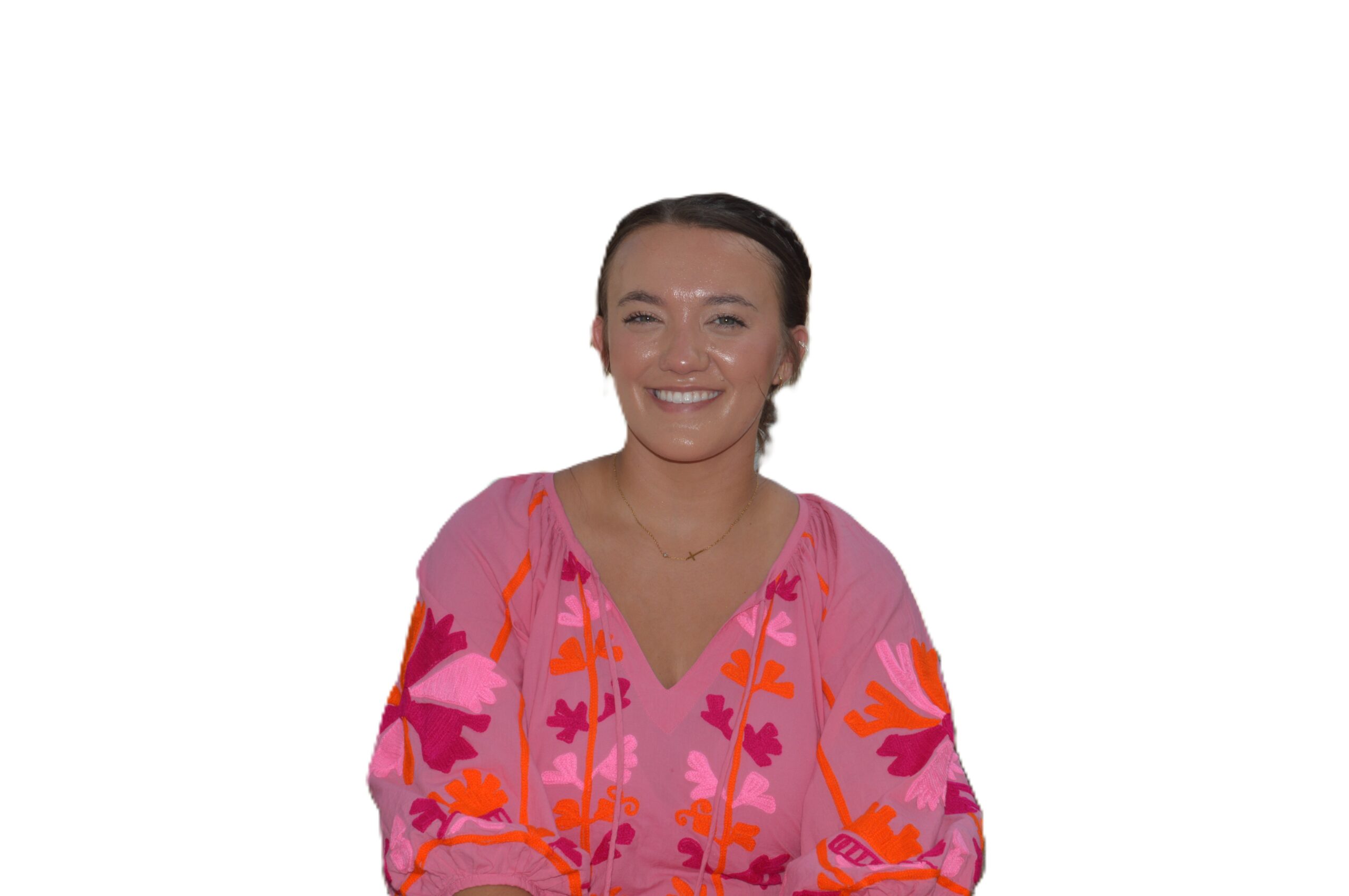 Smiling woman in a colorful pink blouse.